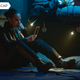Drummer (Cara Gee) sits on her bunk and looks at a hand terminal.